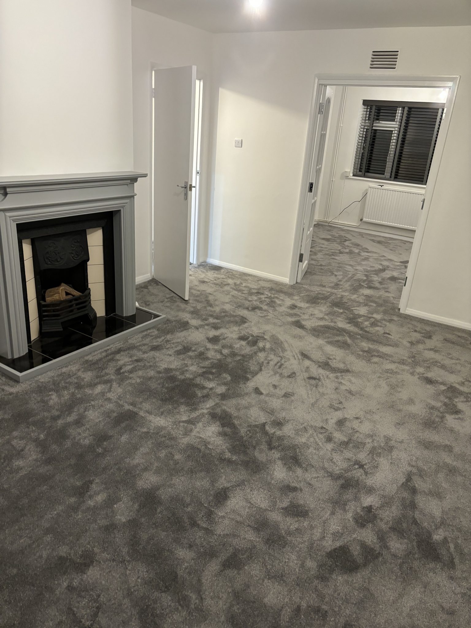 Grey carpet fitted in living room by Strictly Floors