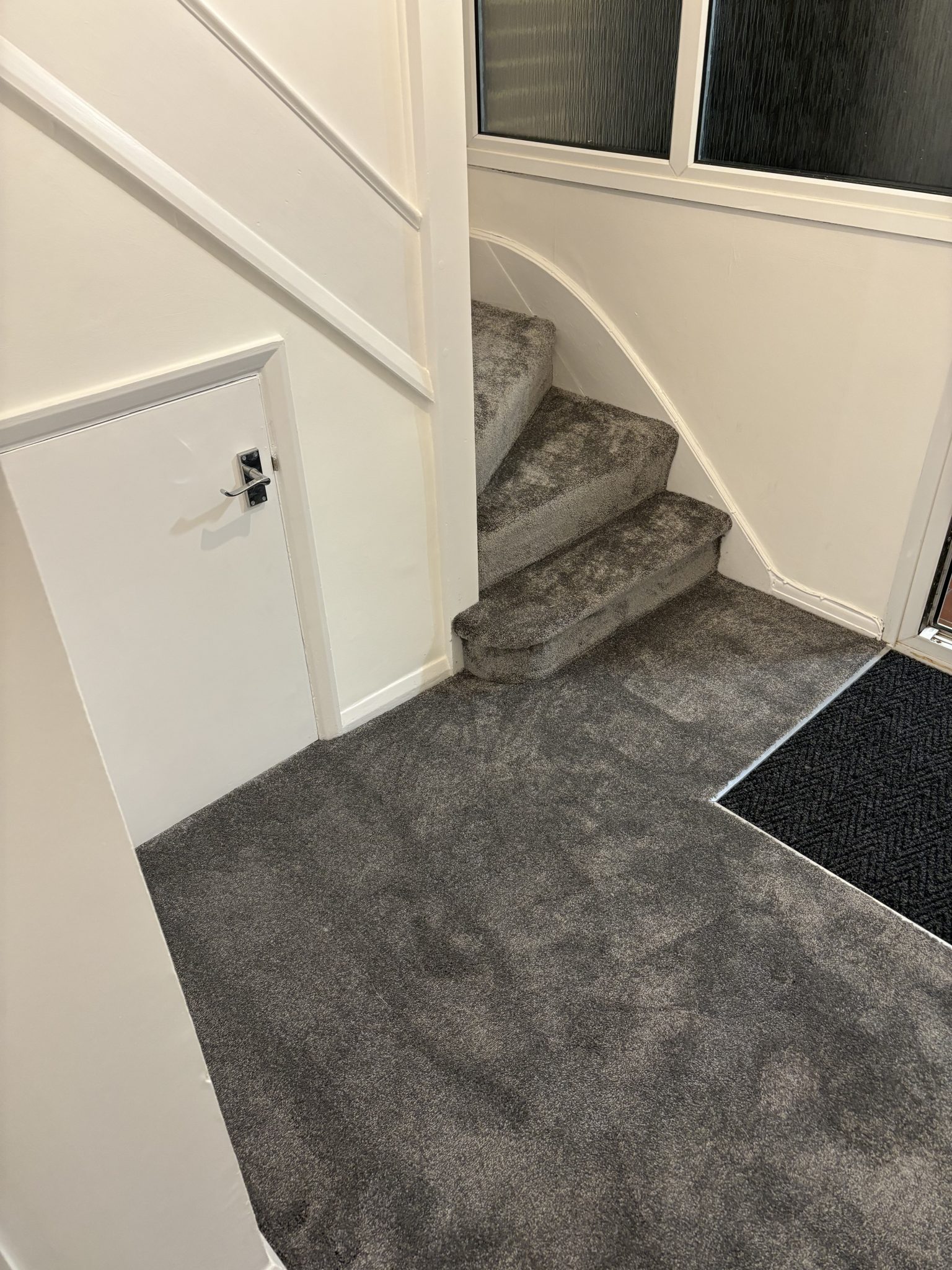 Grey carpet fitted through hallway and staircase by Strictly Floors