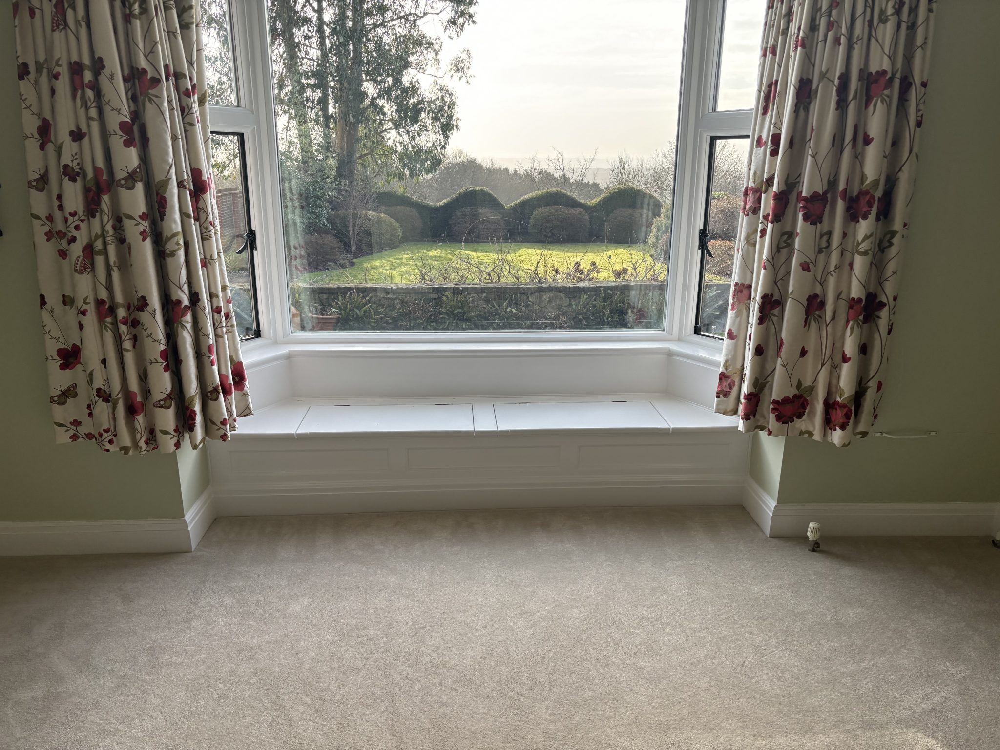 Finished carpet installation in bright bay window room by Strictly Floors