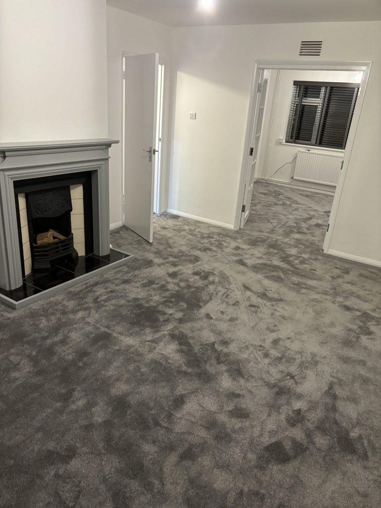 Grey carpet professionally fitted throughout a completed living room and hallway