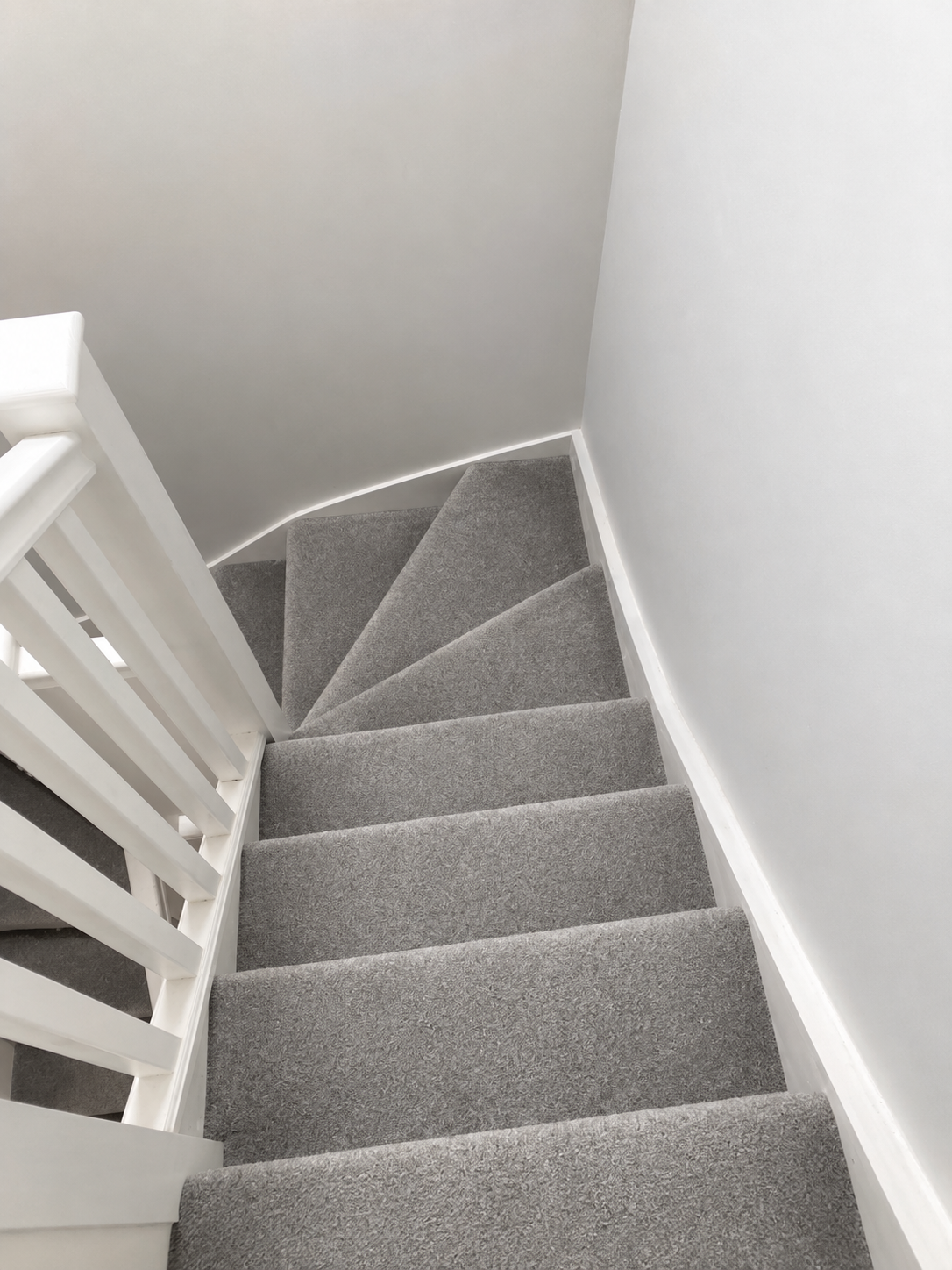 Grey carpet professionally fitted on a staircase by Strictly Floors