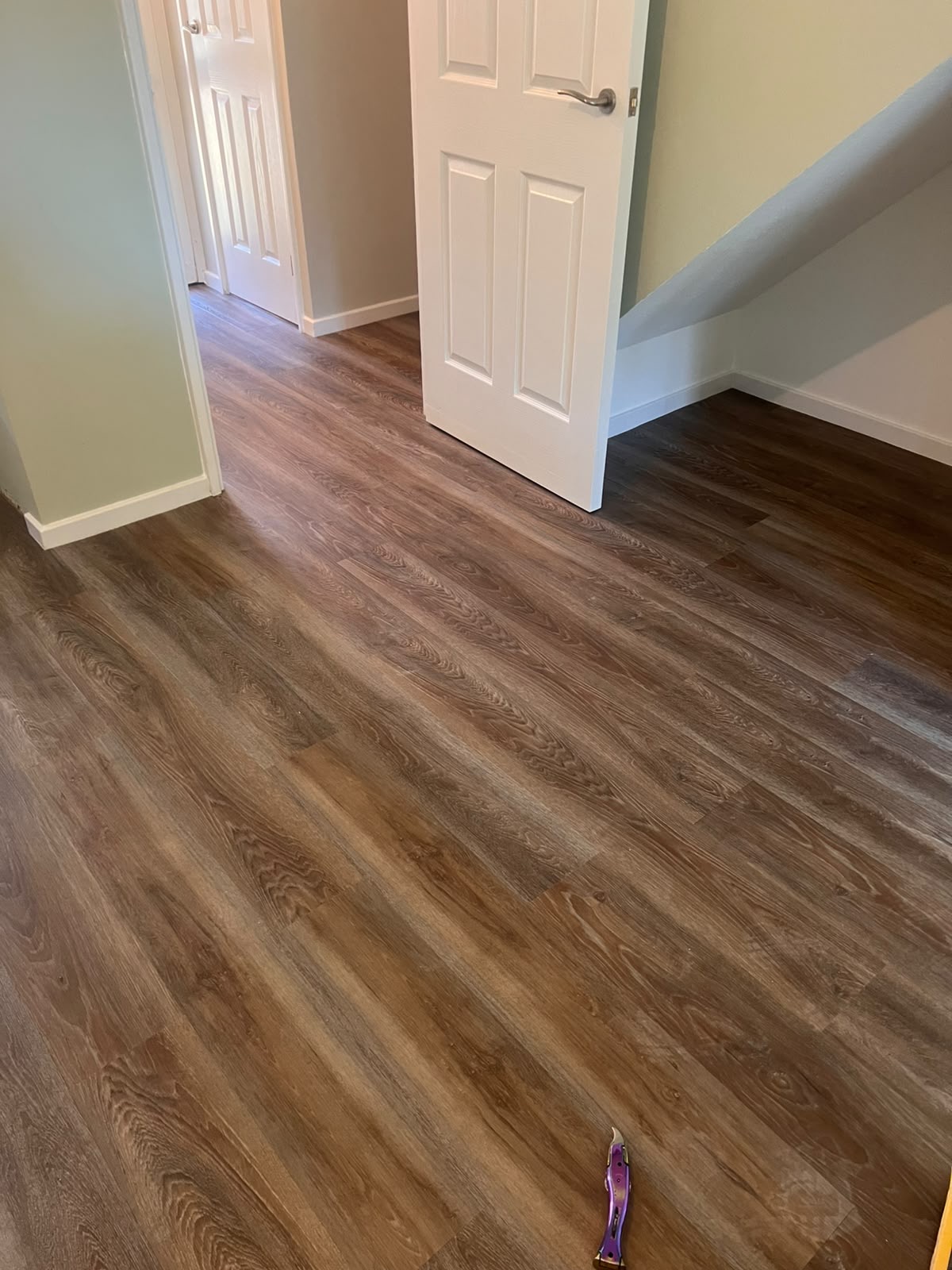 Wood effect LVT professionally fitted through a hallway by Strictly Floors